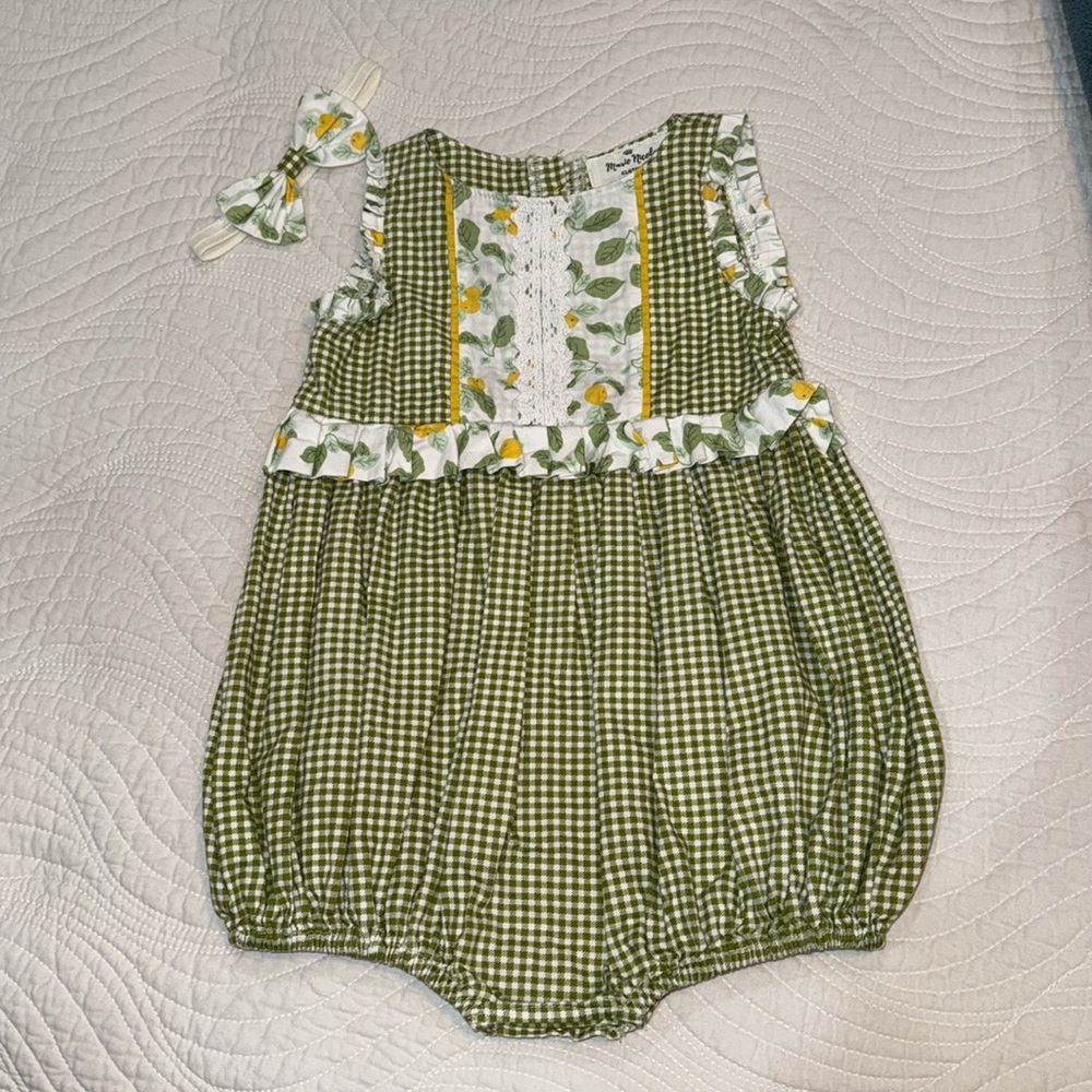 Marie Nicole romper with cute flower buttons in back.